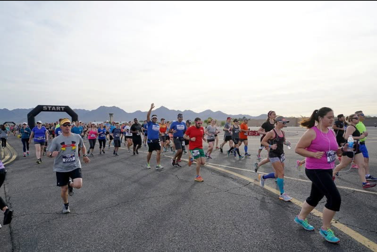 Runners at the start line on the runway