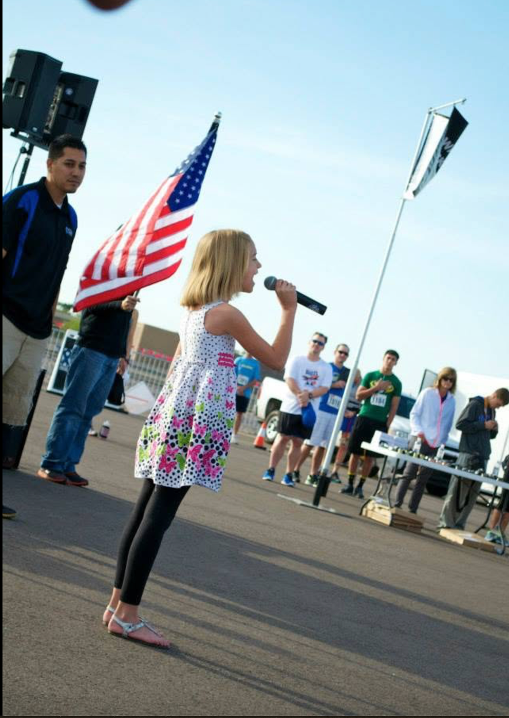 Girl singing the national anthem at race day